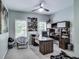Dedicated office space with built-in shelving, large windows, and a sleek ceiling fan at 9698 Coyote Ct, Noblesville, IN 46060