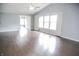 Bright and airy living room with hardwood floors, a ceiling fan and large windows offering abundant natural light at 10112 Split Rock Way, Brownsburg, IN 46112
