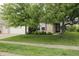 Inviting brick home featuring a lush green lawn and a welcoming entrance under the shade of mature trees at 10112 Split Rock Way, Brownsburg, IN 46112