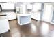 Bright kitchen featuring white cabinetry, stainless steel appliances, and a central island for meal preparation at 10112 Split Rock Way, Brownsburg, IN 46112