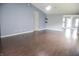 Spacious living room with hardwood floors, neutral walls, and a ceiling fan offering a bright and airy atmosphere at 10112 Split Rock Way, Brownsburg, IN 46112