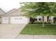 Charming brick home featuring a well-manicured lawn and a two-car garage, perfect for suburban living at 10112 Split Rock Way, Brownsburg, IN 46112