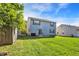 Spacious backyard with a grassy area and blue exterior at 1024 Rotherham Ln, Beech Grove, IN 46107