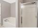 Bathroom featuring a shower with sliding door, and soaking tub at 1024 Rotherham Ln, Beech Grove, IN 46107