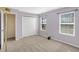 Bright bedroom featuring neutral carpet, two windows, and a closet at 1024 Rotherham Ln, Beech Grove, IN 46107