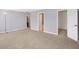 Spacious carpeted bedroom with a neutral wall color and doorways to the bathroom and closet at 1024 Rotherham Ln, Beech Grove, IN 46107