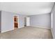 Large bedroom with neutral-colored walls and carpeting with doorways to the bathroom and closet at 1024 Rotherham Ln, Beech Grove, IN 46107