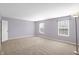 Spacious carpeted bedroom with a neutral wall color and great natural light from two windows at 1024 Rotherham Ln, Beech Grove, IN 46107