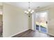 Dining area with wood-look floors and sliding glass doors to the patio at 1024 Rotherham Ln, Beech Grove, IN 46107