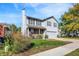 Charming two-story home with light gray siding, green shutters, and a well-manicured lawn at 1024 Rotherham Ln, Beech Grove, IN 46107