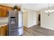 Kitchen featuring stainless refrigerator and open access to a dining area at 1024 Rotherham Ln, Beech Grove, IN 46107