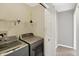 Laundry room with washer, dryer, and storage shelf at 1024 Rotherham Ln, Beech Grove, IN 46107