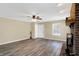 Cozy living area showcasing a brick fireplace, wood flooring, and natural light through the window at 1024 Rotherham Ln, Beech Grove, IN 46107