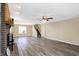 Spacious living room showcasing a brick fireplace, ceiling fan, and attractive wood-look flooring at 1024 Rotherham Ln, Beech Grove, IN 46107