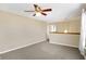 Open-concept living room featuring plush carpeting, ceiling fan, and bright natural light at 1024 Rotherham Ln, Beech Grove, IN 46107