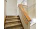 Carpeted staircase with wood railing leading to the second floor of the home at 1024 Rotherham Ln, Beech Grove, IN 46107