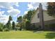 Spacious backyard featuring brick and vinyl siding, mature landscaping, and lush lawn, perfect for outdoor enjoyment at 1065 Lakewood South Dr, Brownsburg, IN 46112