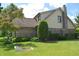 Spacious backyard featuring brick and vinyl siding, mature landscaping, and a horseshoe pit, ideal for outdoor activities at 1065 Lakewood South Dr, Brownsburg, IN 46112