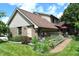Lovely backyard featuring a raised garden bed, brick exterior, and patio area with a red umbrella at 1065 Lakewood South Dr, Brownsburg, IN 46112