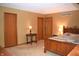 Large carpeted bedroom with three closets, warm lighting, and vintage-style wooden furniture at 1065 Lakewood South Dr, Brownsburg, IN 46112