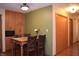 A dining area with wood cabinets, a kitchen view, and a dining table with four chairs at 1065 Lakewood South Dr, Brownsburg, IN 46112