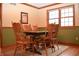 A dining area with a table and six wood chairs, and a view of the outside at 1065 Lakewood South Dr, Brownsburg, IN 46112
