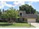 Well-maintained two-story home with lush lawn, mature trees, brick facade, attached garage and mailbox near the street at 1065 Lakewood South Dr, Brownsburg, IN 46112