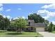 Charming two-story brick home with lush lawn, mature trees, brick facade and attached garage on a sunny day at 1065 Lakewood South Dr, Brownsburg, IN 46112
