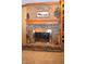 Close up of a brick fireplace with wooden mantel and decorative accessories on the hearth at 1065 Lakewood South Dr, Brownsburg, IN 46112