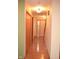 Inviting hallway with gleaming hardwood floors, neutral walls, and classic wood trim throughout at 1065 Lakewood South Dr, Brownsburg, IN 46112