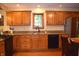 Bright kitchen with wood cabinets, hardwood floors, granite counters and stainless steel refrigerator at 1065 Lakewood South Dr, Brownsburg, IN 46112