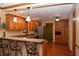 Bright eat-in kitchen features granite counters, wood cabinets, and stainless refrigerator at 1065 Lakewood South Dr, Brownsburg, IN 46112