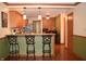 Eat in kitchen with wooden cabinets, granite counters, hardwood floors and breakfast bar at 1065 Lakewood South Dr, Brownsburg, IN 46112