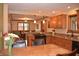 A kitchen and dining area featuring wood cabinets, granite countertops, and modern appliances at 1065 Lakewood South Dr, Brownsburg, IN 46112