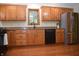 Functional kitchen with stainless appliances, granite countertops, and wooden cabinetry at 1065 Lakewood South Dr, Brownsburg, IN 46112