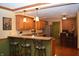 Eat in kitchen with wood cabinets, granite counters, hardwood floors and stainless steel refrigerator at 1065 Lakewood South Dr, Brownsburg, IN 46112