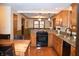 A functional kitchen featuring wood cabinets, granite countertops, and modern appliances at 1065 Lakewood South Dr, Brownsburg, IN 46112