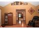 Cozy living area with wood floors, vintage cabinet, and a comfortable chair at 1065 Lakewood South Dr, Brownsburg, IN 46112