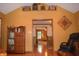 Spacious living area showcasing hardwood floors, an antique cabinet and ample room for entertaining at 1065 Lakewood South Dr, Brownsburg, IN 46112