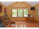 Charming living room with hardwood floors, large windows, and unique barrel table with seating at 1065 Lakewood South Dr, Brownsburg, IN 46112