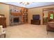 Spacious living room featuring a brick fireplace, carpeted floors, and decorative wood trim at 1065 Lakewood South Dr, Brownsburg, IN 46112