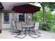 Covered patio with an outdoor dining set and a red umbrella, perfect for entertaining outdoors at 1065 Lakewood South Dr, Brownsburg, IN 46112