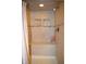 Modern shower with tiled walls, a built-in seat, recessed shelving, and a shower head at 1065 Lakewood South Dr, Brownsburg, IN 46112