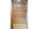 Tiled walk-in shower with built-in bench, recessed shelves, and neutral colors create a relaxing space at 1065 Lakewood South Dr, Brownsburg, IN 46112
