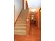Carpeted staircase leading to the second floor, with wood railing and hardwood floors visible below at 1065 Lakewood South Dr, Brownsburg, IN 46112
