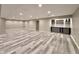 Spacious basement with modern gray flooring and a built-in bar at 10725 Tedder Lake Dr, Indianapolis, IN 46239
