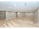 Spacious basement featuring laminate flooring and recessed lighting, perfect for a rec room or entertainment area at 10725 Tedder Lake Dr, Indianapolis, IN 46239