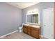 Well-lit bathroom offers a double vanity, toilet, and a shower behind the door at 10725 Tedder Lake Dr, Indianapolis, IN 46239