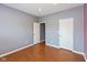 Spacious bedroom with hardwood flooring and multiple doors for easy access at 10725 Tedder Lake Dr, Indianapolis, IN 46239