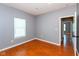 Bedroom with hardwood floors, window, and neutral paint at 10725 Tedder Lake Dr, Indianapolis, IN 46239